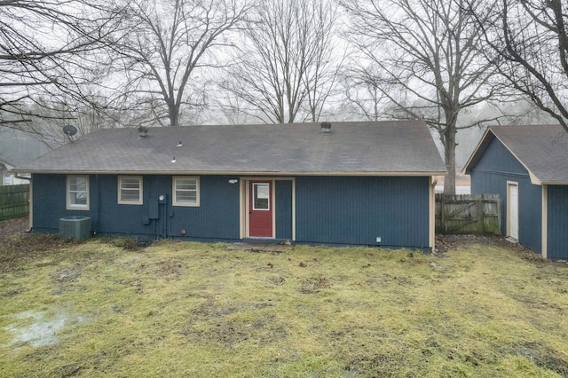 rear view of property with a yard and central AC unit