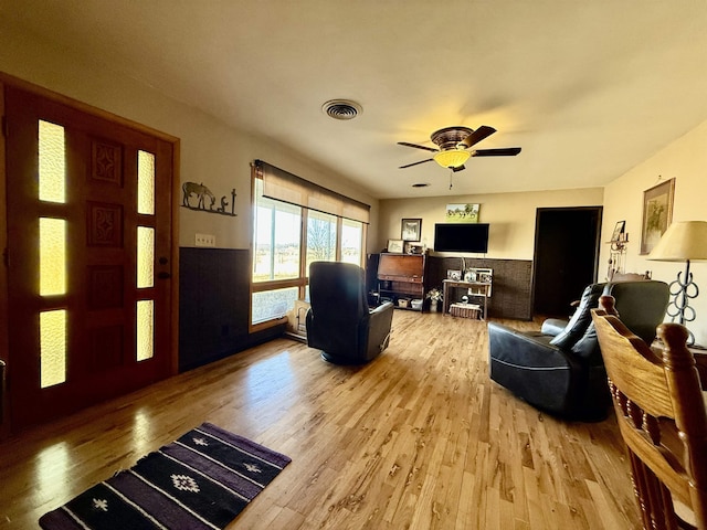 living room with ceiling fan and light hardwood / wood-style floors