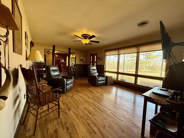 living room with hardwood / wood-style flooring and ceiling fan