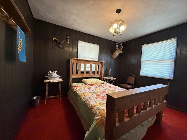 bedroom featuring dark carpet and an inviting chandelier