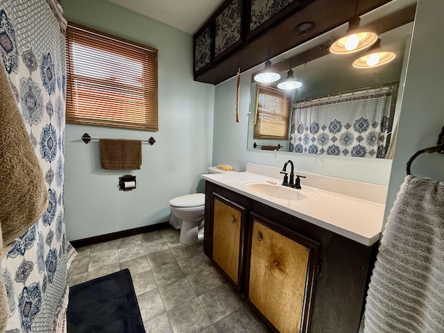 bathroom featuring vanity, tile patterned floors, and toilet