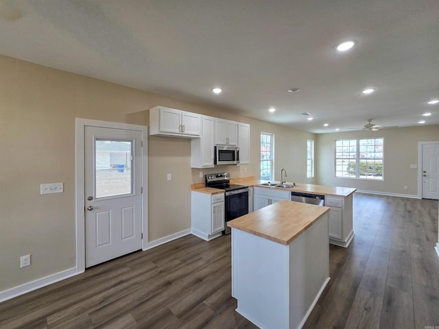 111 Brigance St, Marked Tree, AR 72365 - kitchen with appliances with stainless steel finishes, white cabinets, and kitchen peninsula