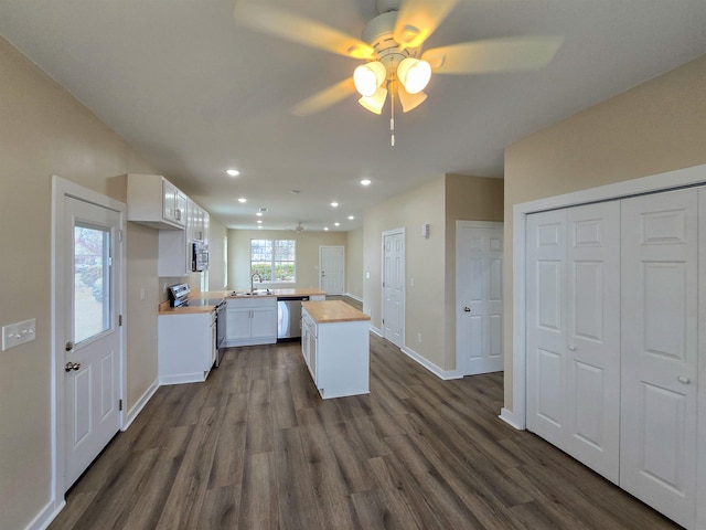 111 Brigance St, Marked Tree, AR 72365 - kitchen with wood counters, sink, appliances with stainless steel finishes, dark hardwood / wood-style floors, and white cabinets