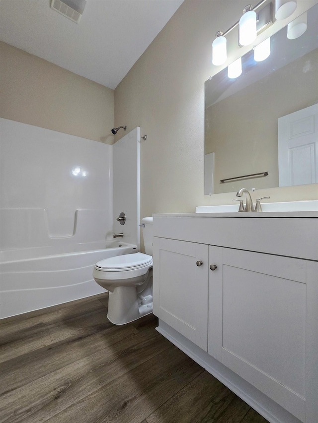 111 Brigance St, Marked Tree, AR 72365 - full bathroom with vanity, wood-type flooring, toilet, and washtub / shower combination