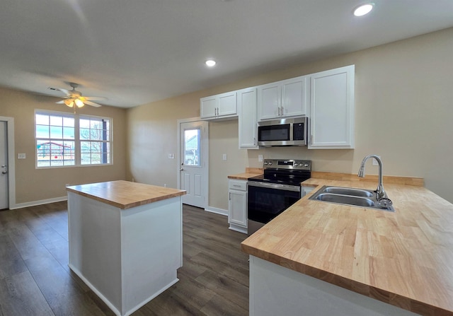 111 Brigance St, Marked Tree, AR 72365 - kitchen featuring appliances with stainless steel finishes, wood counters, sink, white cabinets, and kitchen peninsula