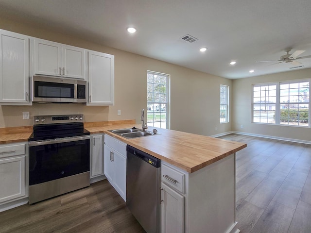 111 Brigance St, Marked Tree, AR 72365 - kitchen with stainless steel appliances, butcher block counters, sink, and kitchen peninsula