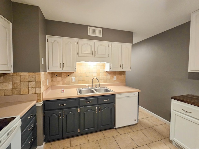 kitchen featuring sink, white cabinetry, stove, white dishwasher, and decorative backsplash