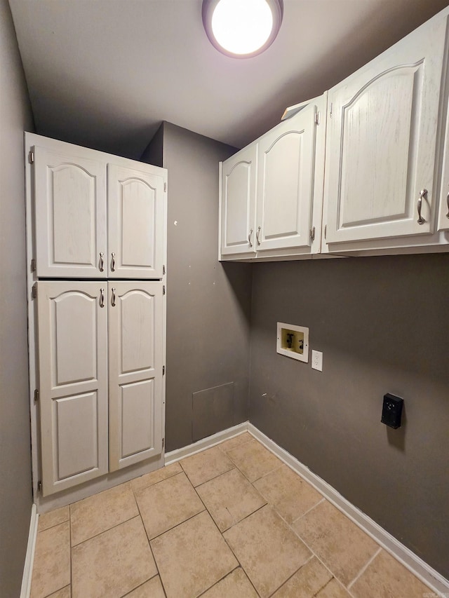 laundry room featuring cabinets, hookup for a washing machine, and light tile patterned floors