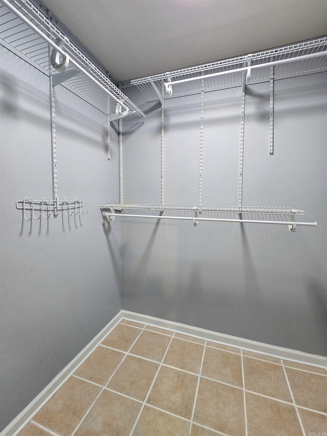 spacious closet featuring tile patterned floors