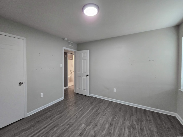 unfurnished bedroom with dark wood-type flooring