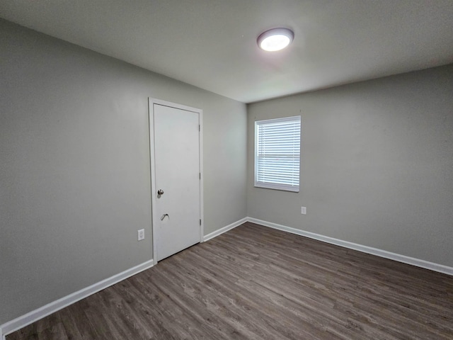 unfurnished room featuring dark hardwood / wood-style floors