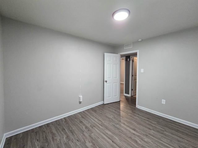 empty room with dark wood-type flooring