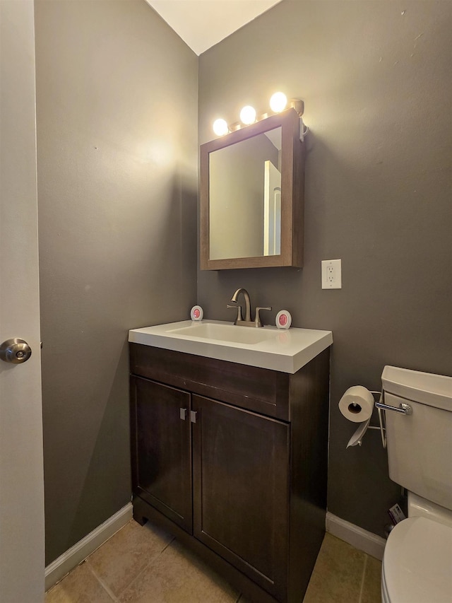 bathroom with vanity, tile patterned flooring, and toilet