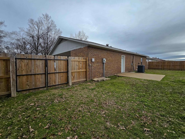 rear view of property featuring cooling unit, a patio, and a lawn