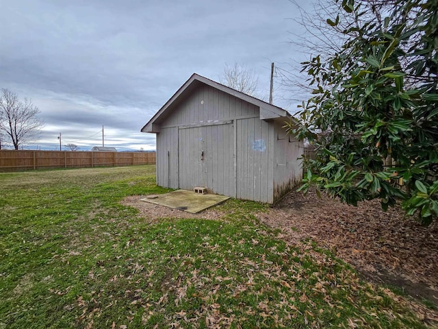 view of outbuilding with a yard