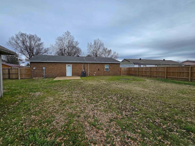 back of property featuring a yard, central AC, and a patio area