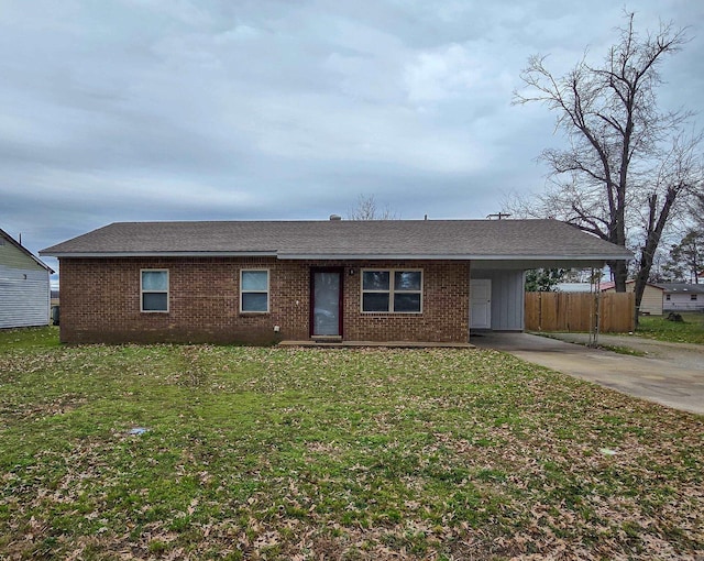 ranch-style house featuring a carport and a front yard