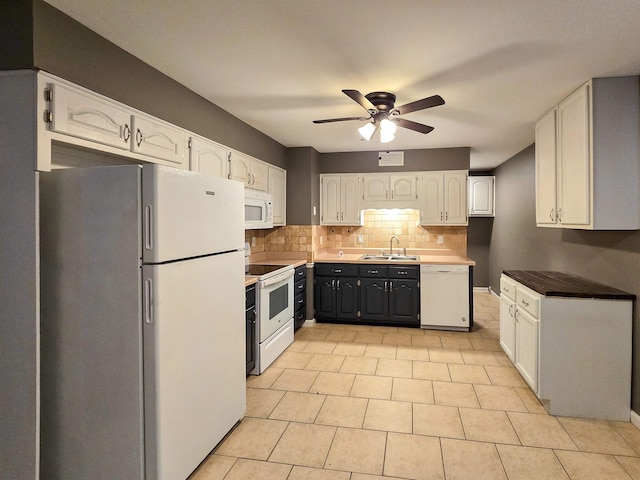 kitchen featuring sink, white appliances, ceiling fan, backsplash, and white cabinets