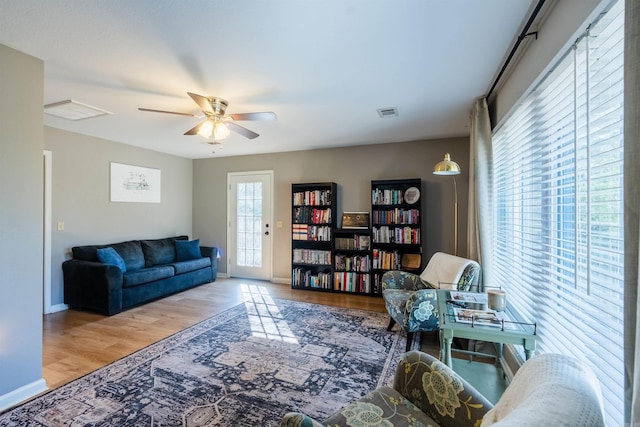 living room featuring ceiling fan and hardwood / wood-style floors