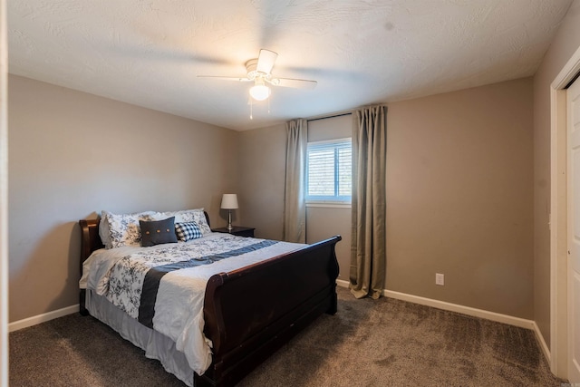 bedroom with ceiling fan, a textured ceiling, and dark carpet