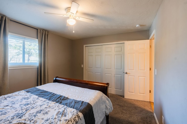 bedroom with a textured ceiling, a closet, ceiling fan, and carpet