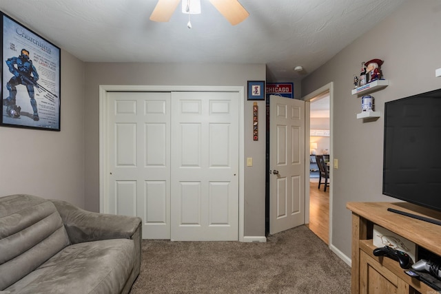 interior space featuring ceiling fan and carpet