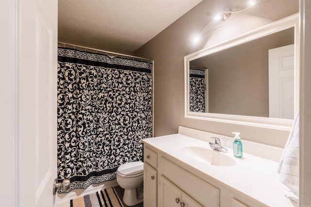 bathroom featuring vanity and toilet