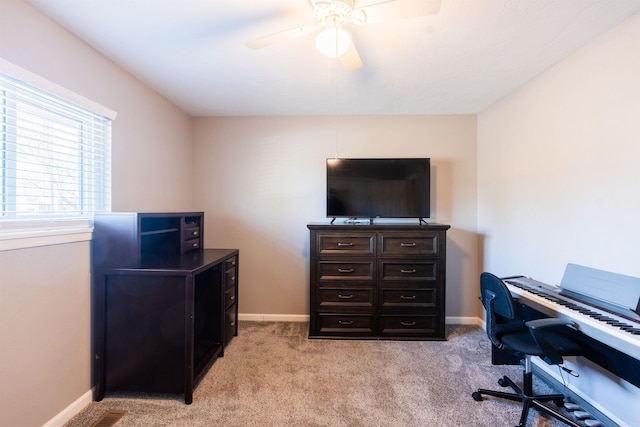 office featuring ceiling fan and light carpet