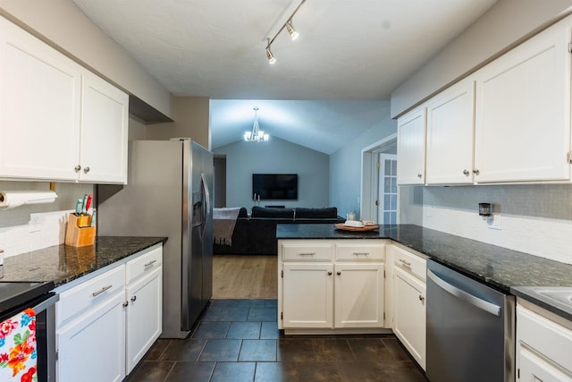 kitchen featuring an inviting chandelier, decorative backsplash, white cabinets, and appliances with stainless steel finishes