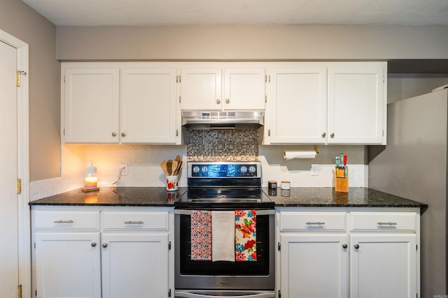 kitchen featuring tasteful backsplash, white cabinetry, appliances with stainless steel finishes, and dark stone counters