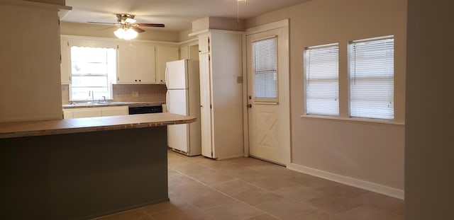 kitchen with ceiling fan, tile counters, white cabinets, decorative backsplash, and white fridge