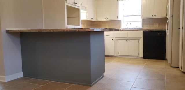 kitchen with white cabinetry, black dishwasher, sink, and decorative backsplash