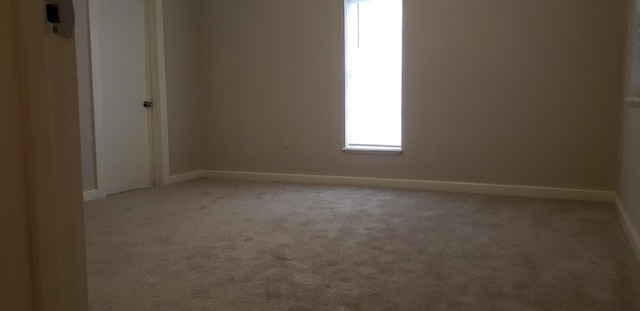 empty room featuring light carpet