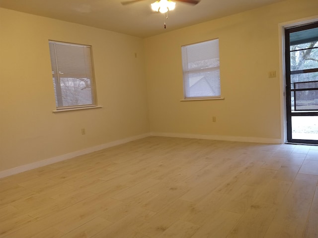 empty room featuring ceiling fan and light wood-type flooring