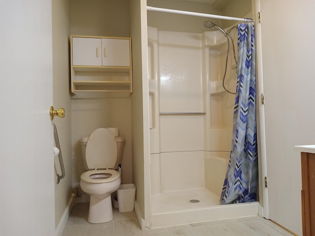 bathroom with vanity, curtained shower, tile patterned floors, and toilet