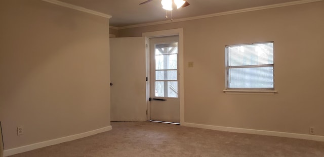 carpeted spare room with crown molding and ceiling fan