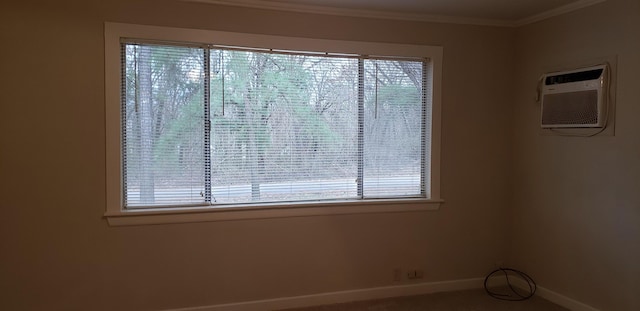 spare room with crown molding, a wealth of natural light, and an AC wall unit