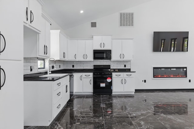 kitchen with marble finish floor, visible vents, a sink, and black appliances