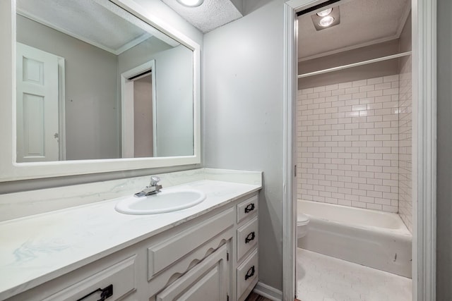 full bathroom with vanity, toilet, tiled shower / bath combo, and a textured ceiling