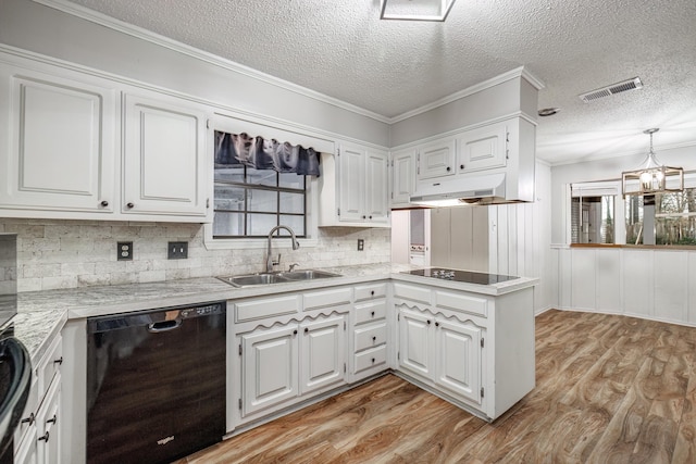 kitchen with sink, pendant lighting, white cabinets, and black appliances