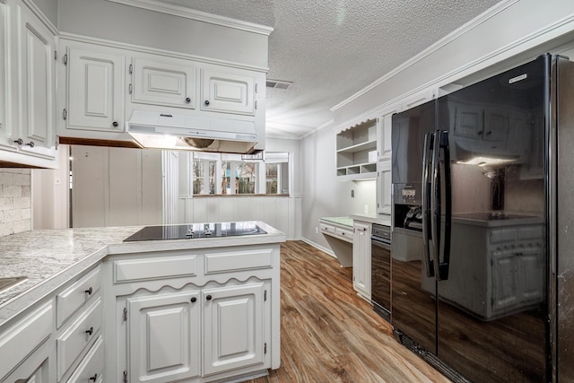 kitchen with crown molding, black appliances, a textured ceiling, light hardwood / wood-style flooring, and white cabinets