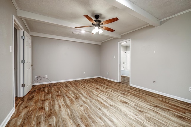 unfurnished bedroom featuring connected bathroom, a textured ceiling, light wood-type flooring, beamed ceiling, and ceiling fan