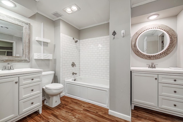 full bathroom with hardwood / wood-style flooring, vanity, and tiled shower / bath combo