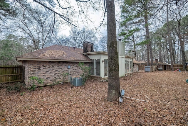 rear view of property featuring central AC unit