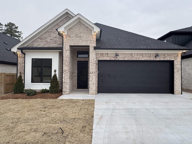 view of front of house featuring a garage and a front lawn