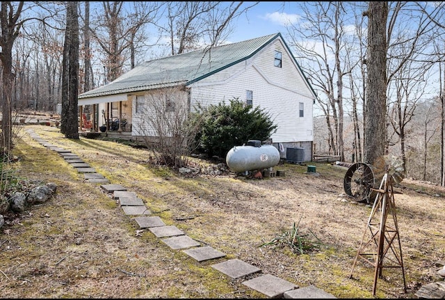 view of side of property with central air condition unit