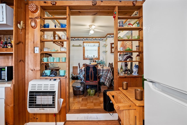 kitchen featuring white refrigerator, parquet flooring, heating unit, and ceiling fan