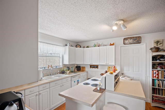 kitchen with a kitchen island, dishwasher, sink, white cabinets, and a textured ceiling