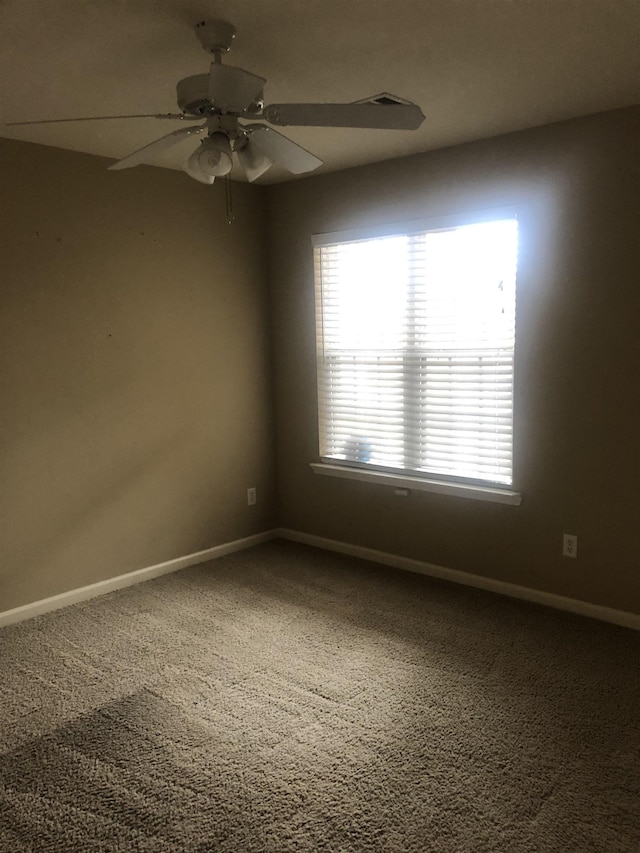 empty room featuring carpet floors and ceiling fan