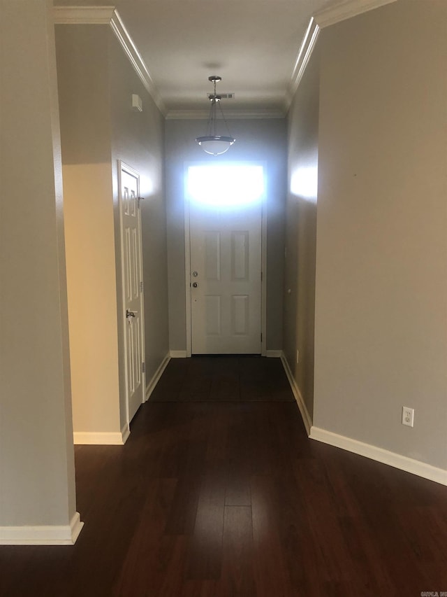 doorway with dark wood-type flooring and ornamental molding